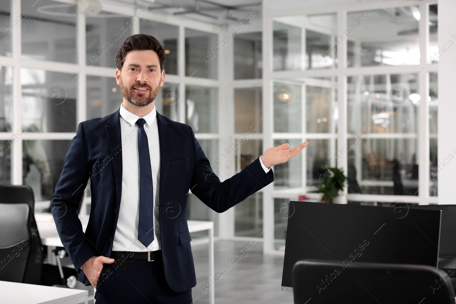 Photo of Male real estate agent indoors. Space for text