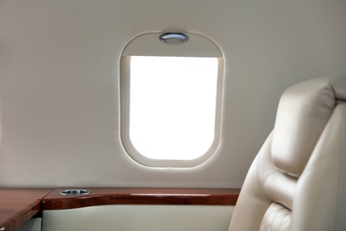 Image of Airplane cabin with comfortable seat and table