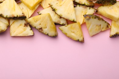 Pieces of tasty ripe pineapple on pink background, flat lay. Space for text