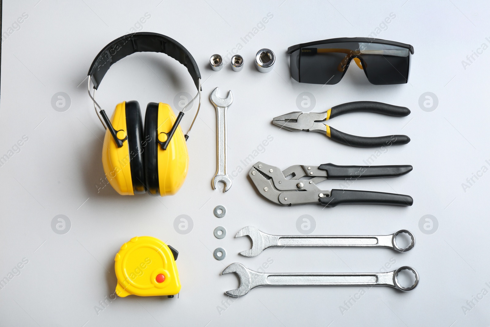 Photo of Flat lay composition with different construction tools on white background