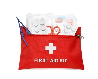Photo of Red first aid kit with scissors, pills, plastic forceps and medical plasters isolated on white, top view
