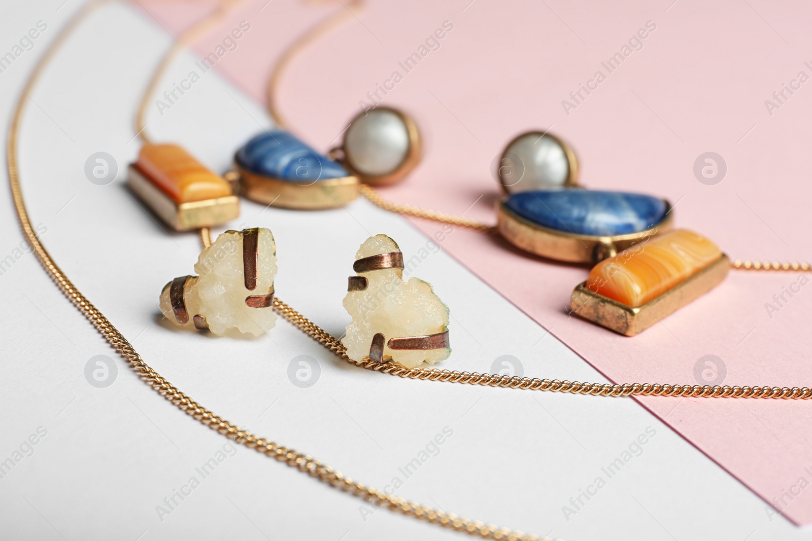 Photo of Set of elegant jewelry on color background