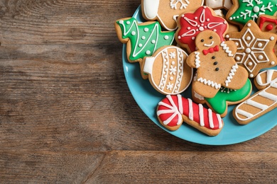 Tasty homemade Christmas cookies on wooden table, top view. Space for text