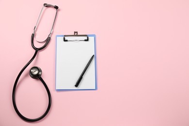 Photo of Endocrinology. Stethoscope, clipboard and pen on pink background, top view. Space for text