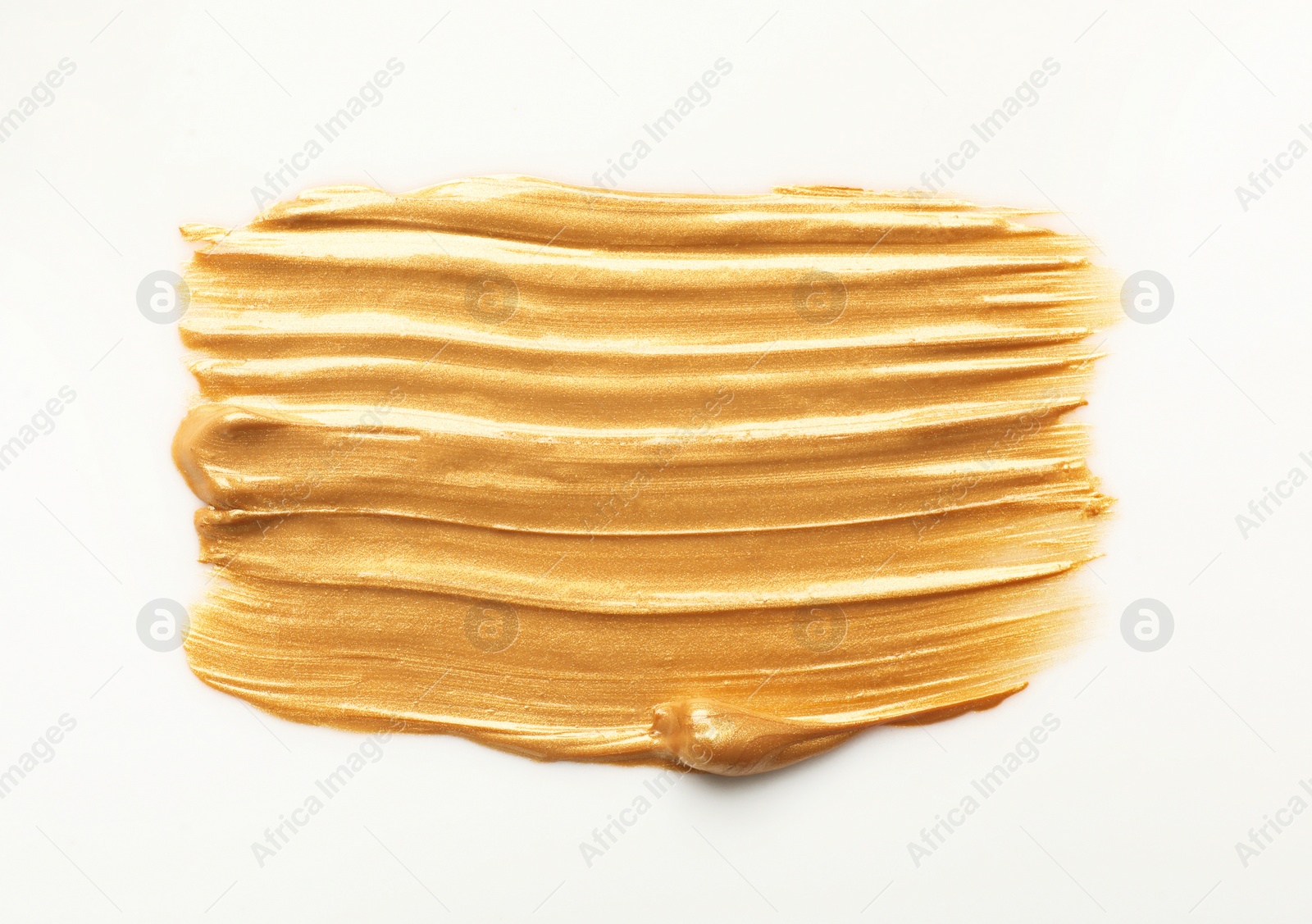 Photo of Stroke of gold paint isolated on white, top view