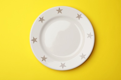 Photo of Clean empty plate on color background, top view