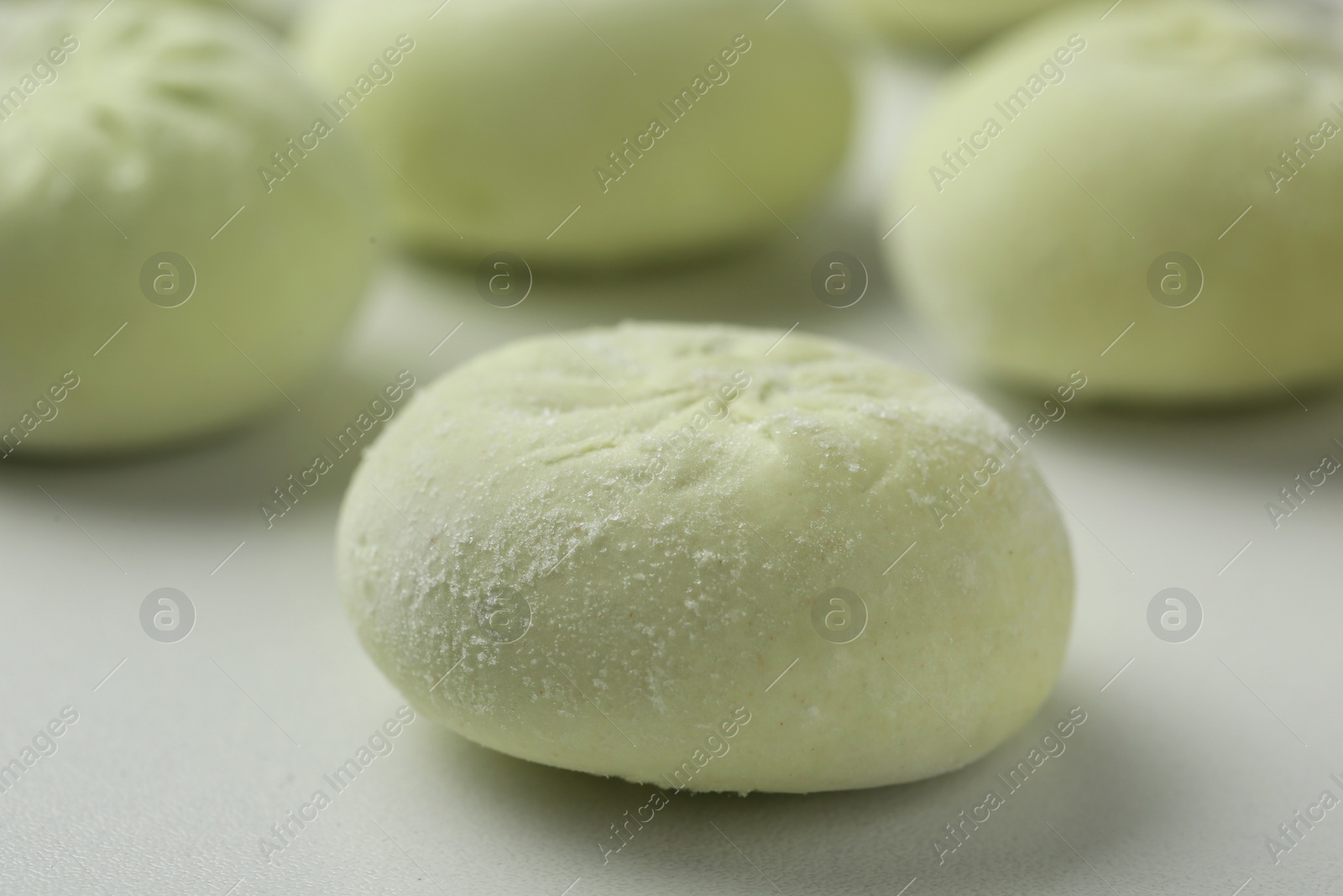 Photo of Frozen raw dumpling on white background, closeup