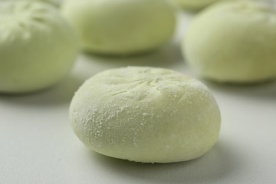 Photo of Frozen raw dumpling on white background, closeup