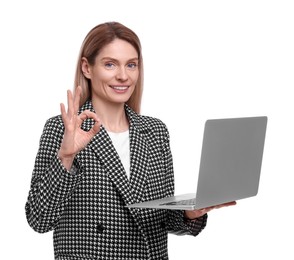 Beautiful happy businesswoman with laptop showing ok gesture on white background