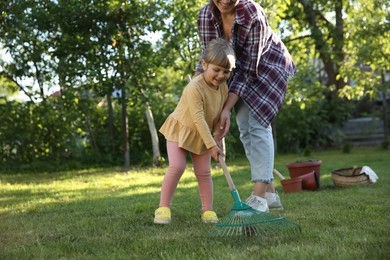 Mother and her daughter working together in garden