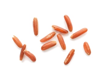 Scattered grains of brown rice on white background, top view