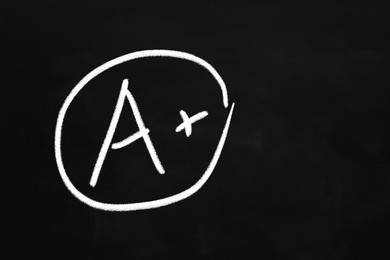 School grade. Chalked letter A with plus symbol on blackboard