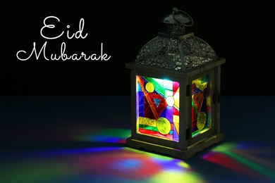 Eid Mubarak greeting card. Arabic lantern on dark background