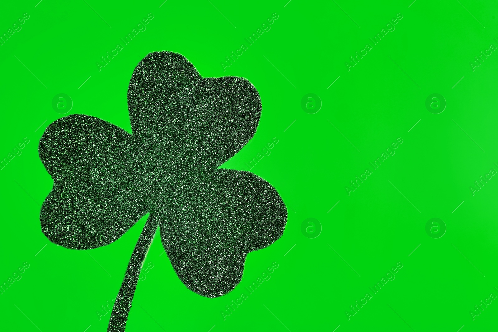 Photo of Decorative clover leaf on green background, space for text. Saint Patrick's Day celebration