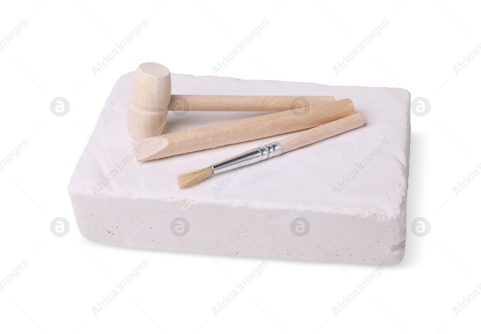 Photo of Educational toy for motor skills development. Excavation kit (plaster, digging tools and brush) on white background