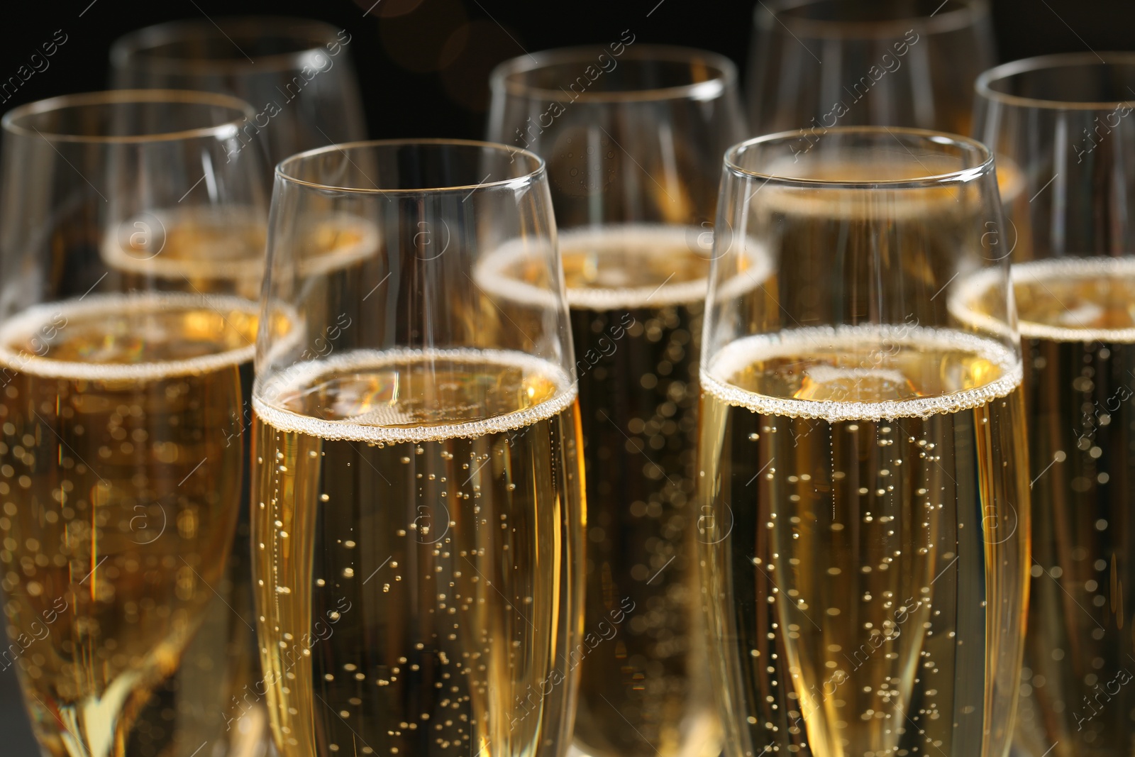 Photo of Glasses of champagne on dark background, closeup