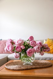 Photo of Beautiful pink peonies in vase on table at home, space for text. Interior design