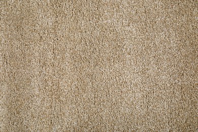 Photo of Stylish soft beige carpet as background, top view