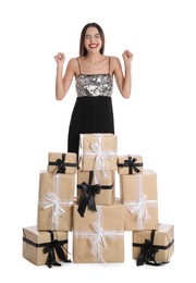 Photo of Excited woman in party dress with Christmas gifts on white background