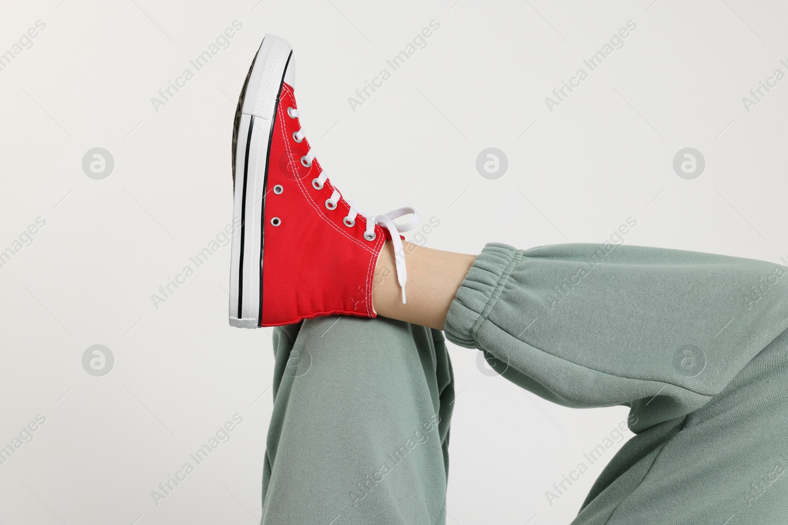Photo of Woman in stylish gumshoes on white background, closeup
