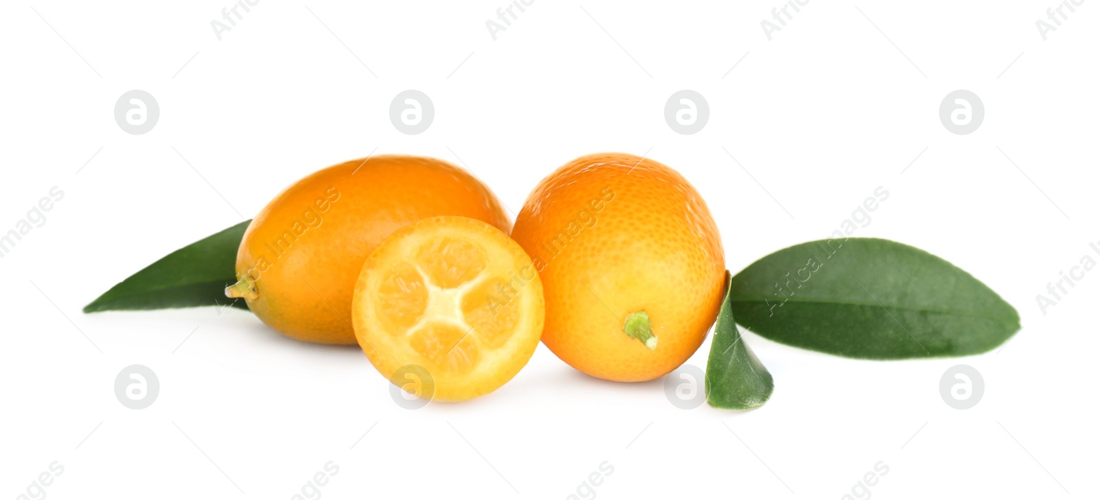 Photo of Whole and cut ripe kumquats with leaves on white background. Exotic fruit