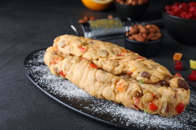Photo of Unbaked Stollen with candied fruits and raisins on grey table, closeup