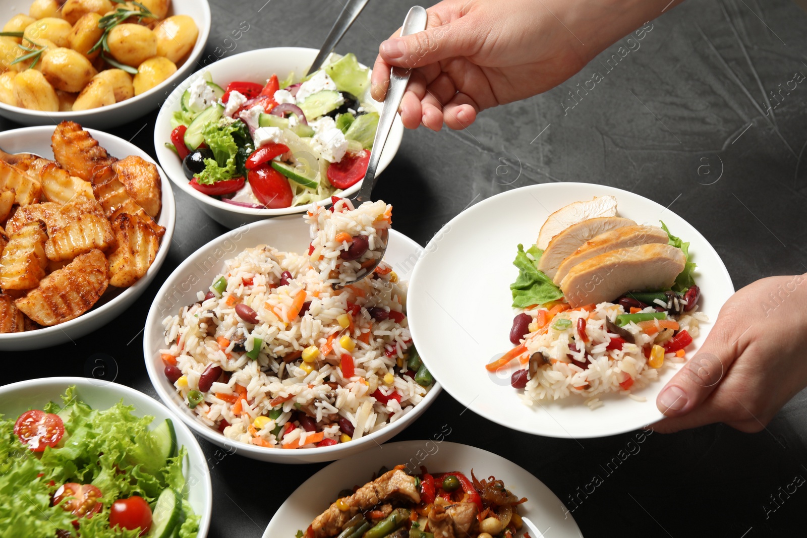 Photo of Woman taking food from buffet table, closeup