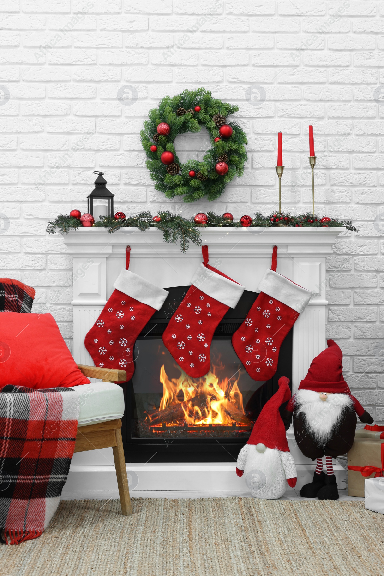 Photo of Cosy room with fireplace decorated for Christmas. Interior design