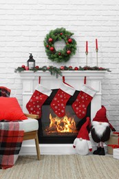 Photo of Cosy room with fireplace decorated for Christmas. Interior design