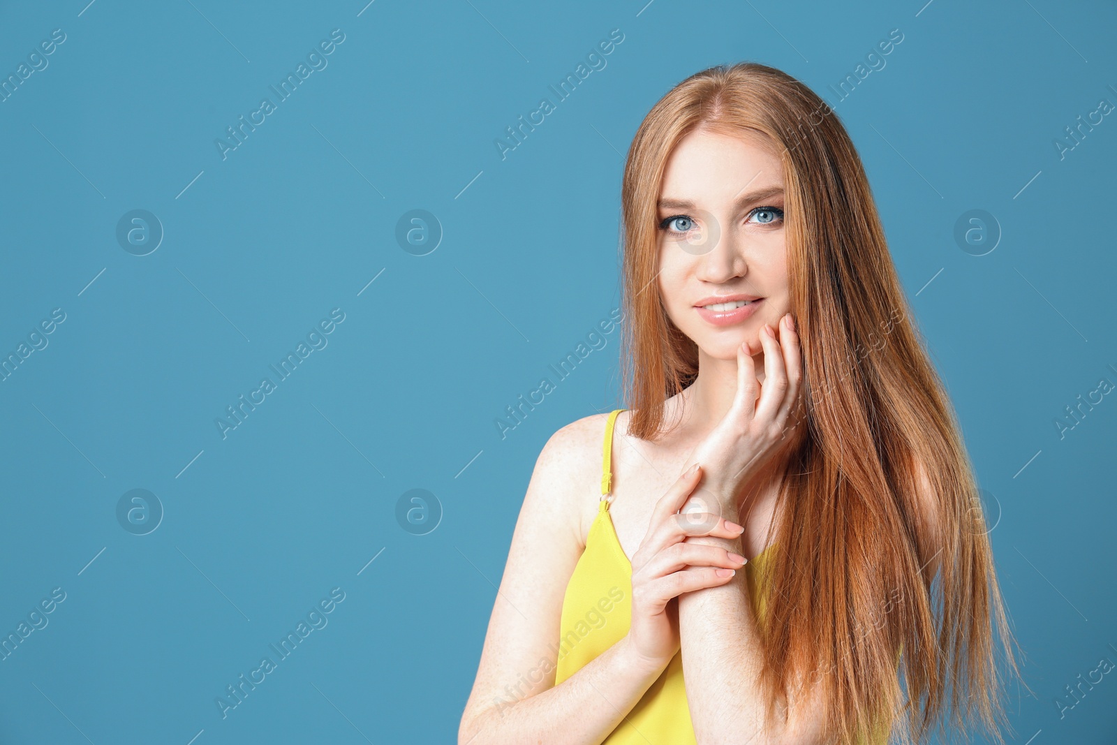 Photo of Portrait of young model with beautiful  hair on color background