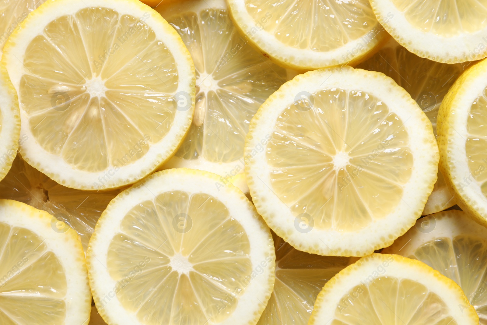 Photo of Slices of fresh lemons as background, top view