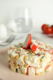 Photo of Delicious salad with fresh crab sticks on plate, closeup