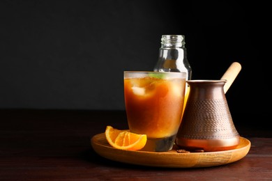 Photo of Tasty refreshing drink with coffee and orange juice on wooden table, space for text