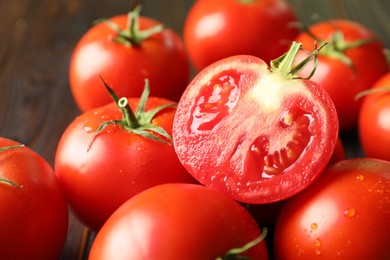 Fresh ripe tomatoes on wooden table, closeup