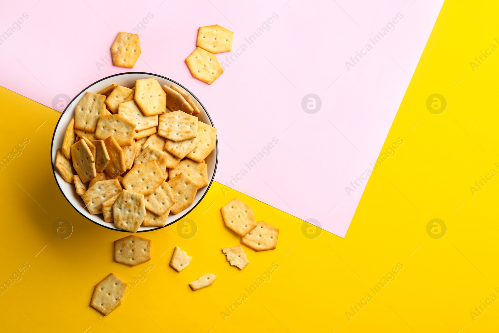 Photo of Delicious crackers on color background, flat lay. Space for text