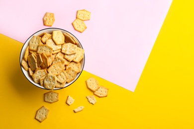 Delicious crackers on color background, flat lay. Space for text