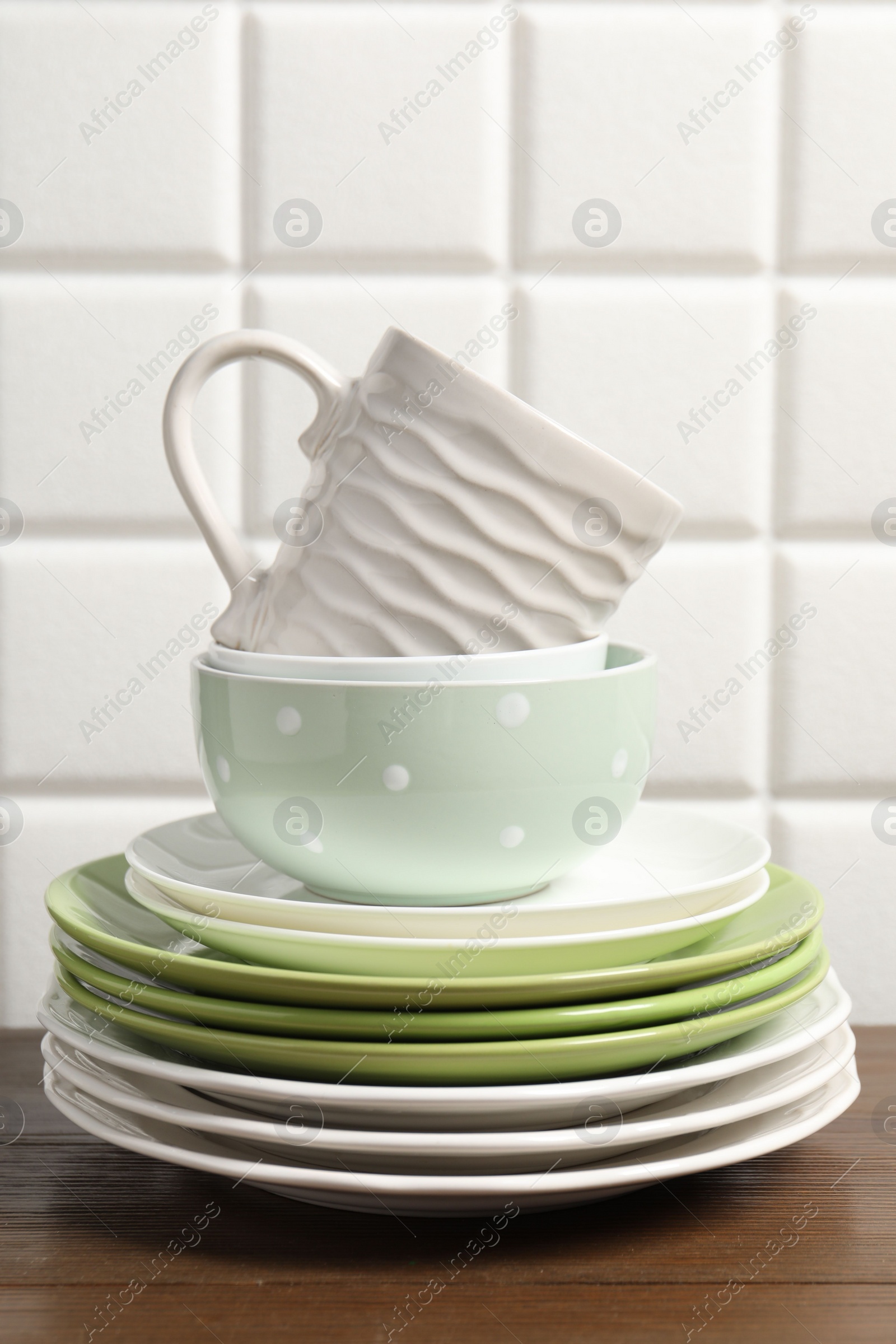 Photo of Beautiful ceramic dishware and cup on wooden table