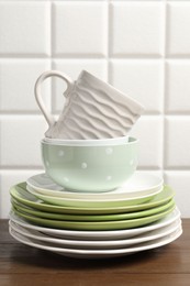 Photo of Beautiful ceramic dishware and cup on wooden table