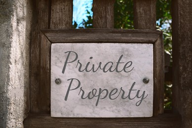 Image of Sign with text Private Property on wooden fence