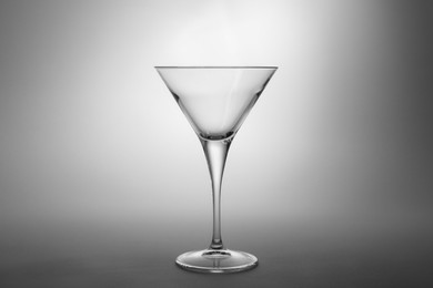 Photo of Elegant empty martini glass on grey background