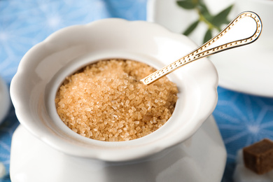 Photo of Ceramic bowl with brown sugar and spoon, closeup