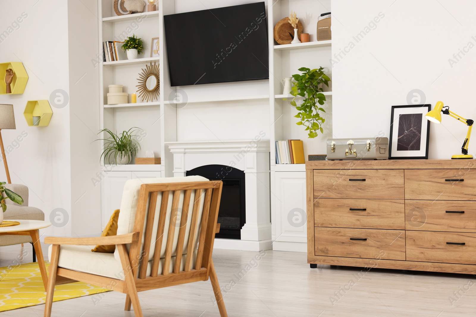 Photo of Spring atmosphere. Stylish room interior with cozy furniture and fireplace