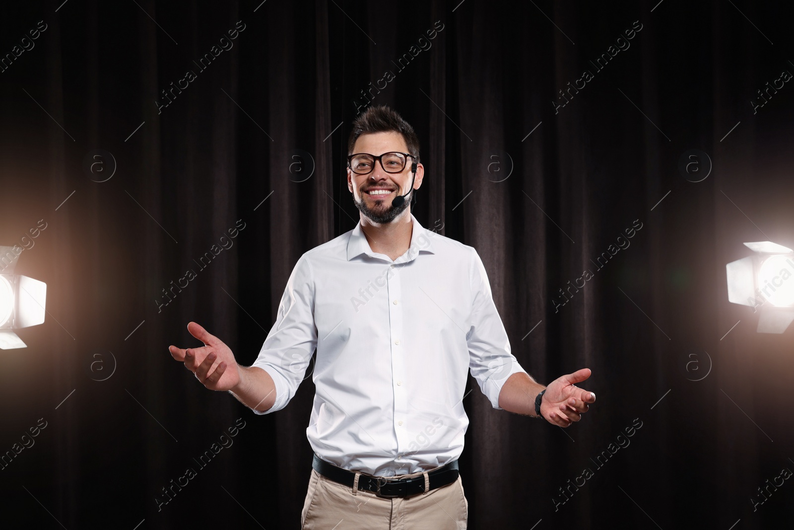 Photo of Motivational speaker with headset performing on stage