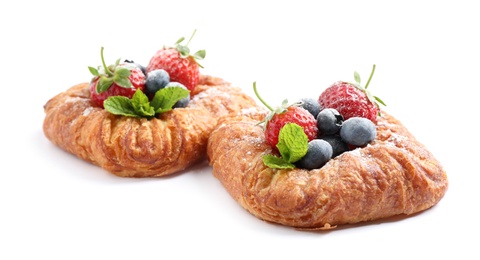 Fresh delicious puff pastry with sweet berries on white background