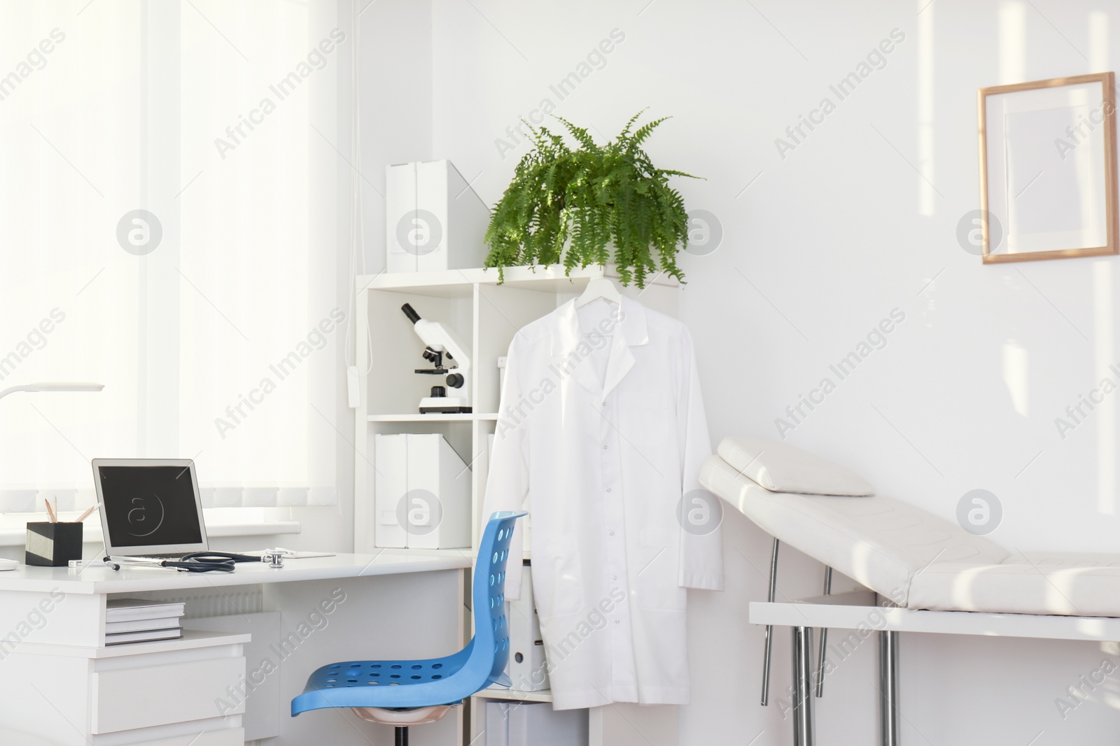 Photo of Interior of modern medical office with doctor's workplace