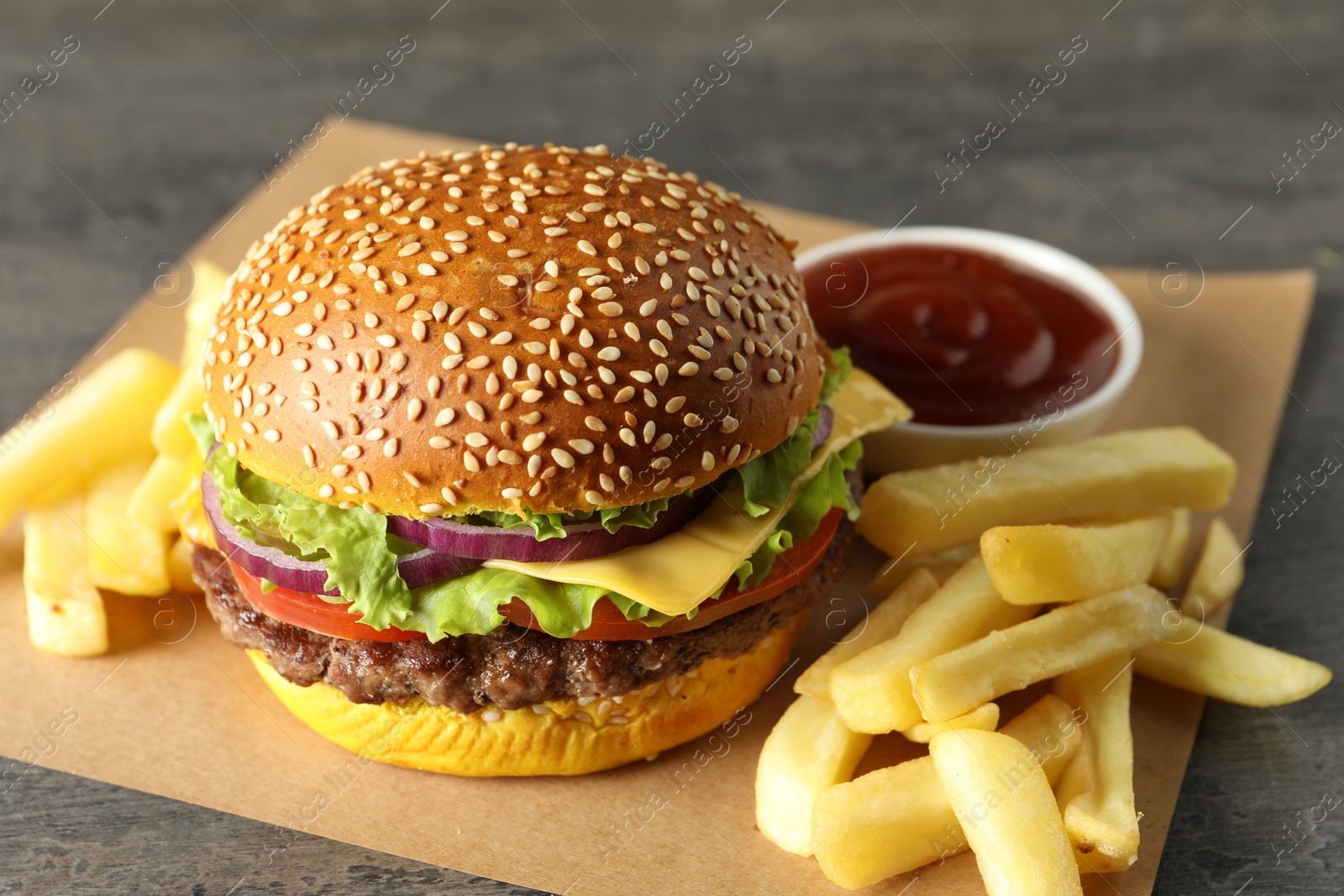 Burger with delicious patty, french fries and sauce on table, closeup Photo of Burger with delicious patty, french fries and sauce on table, closeup