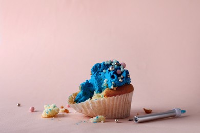 Photo of Failed cupcake and candle on pink background. Troubles happen