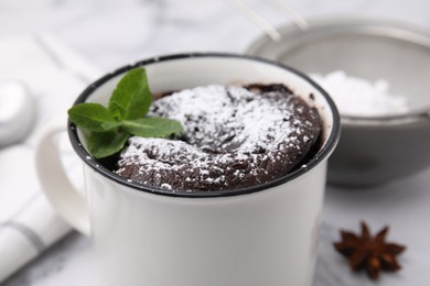 Photo of Tasty chocolate mug pie on table, closeup. Microwave cake recipe