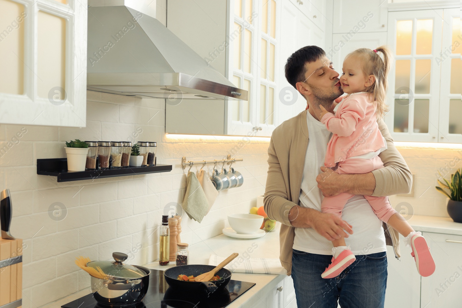 Photo of Father and daughter spending time together in kitchen