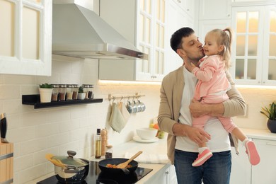 Photo of Father and daughter spending time together in kitchen